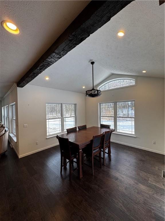 dining area with a textured ceiling, lofted ceiling with beams, dark hardwood / wood-style floors, and a healthy amount of sunlight