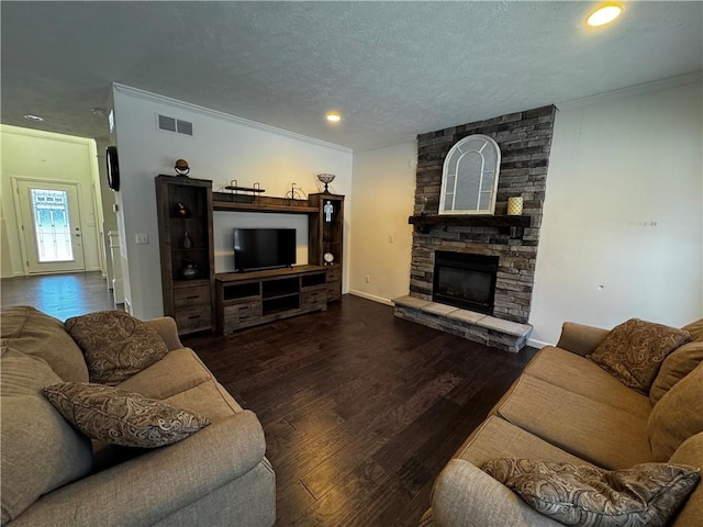 living room with crown molding, a fireplace, and dark hardwood / wood-style flooring