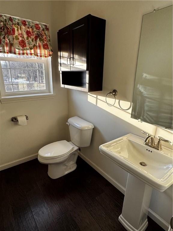 bathroom with sink, hardwood / wood-style flooring, and toilet