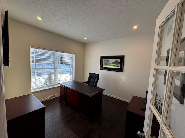 office area featuring dark hardwood / wood-style floors and a textured ceiling