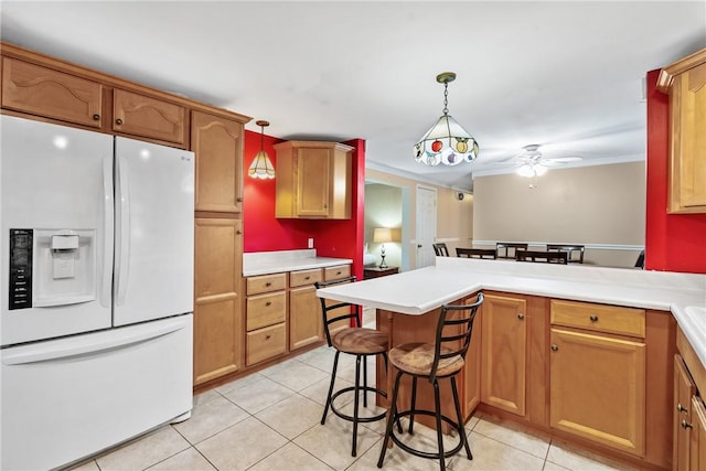 kitchen featuring hanging light fixtures, light tile patterned floors, a kitchen breakfast bar, kitchen peninsula, and white fridge with ice dispenser