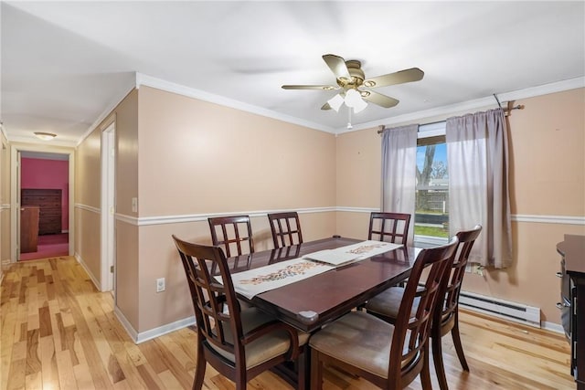 dining area with crown molding, a baseboard radiator, and light hardwood / wood-style flooring