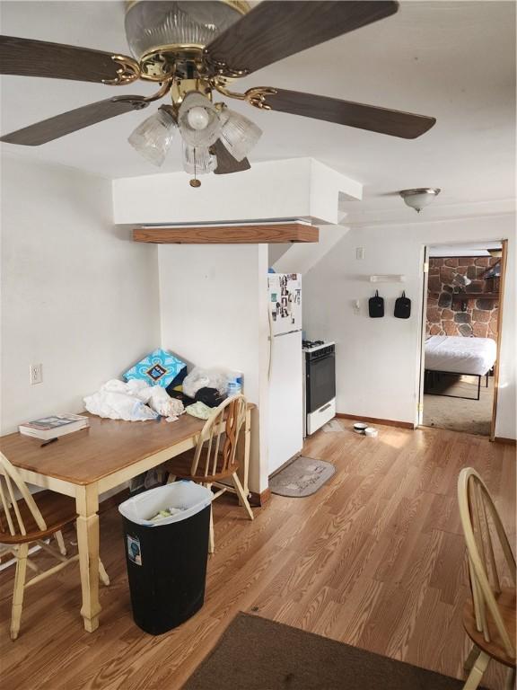 dining area with hardwood / wood-style flooring and ceiling fan