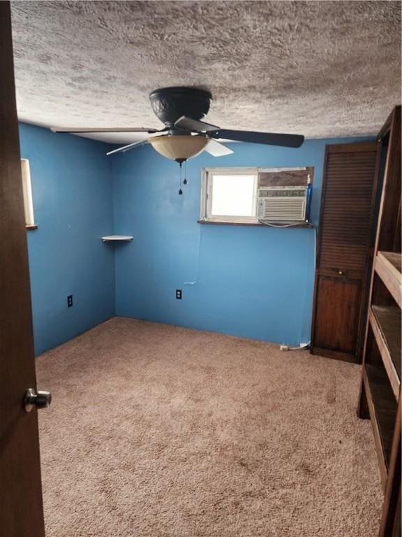 unfurnished room with ceiling fan, carpet floors, and a textured ceiling