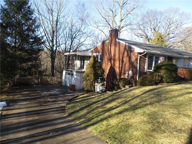 view of property exterior with a garage and a lawn