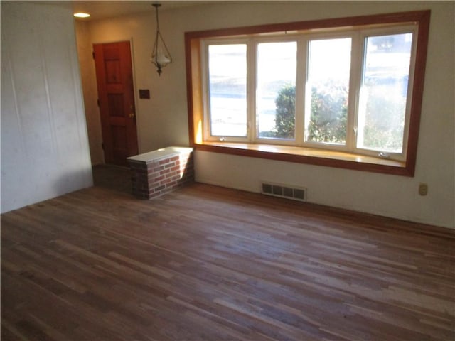 spare room featuring dark wood-type flooring