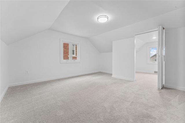 additional living space with lofted ceiling and light colored carpet