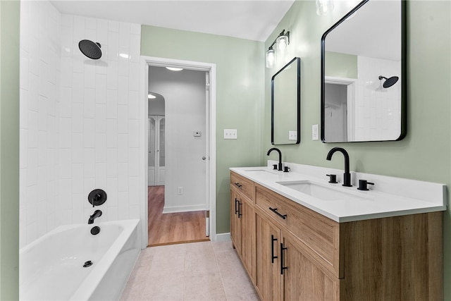 bathroom featuring vanity, tiled shower / bath combo, and tile patterned flooring