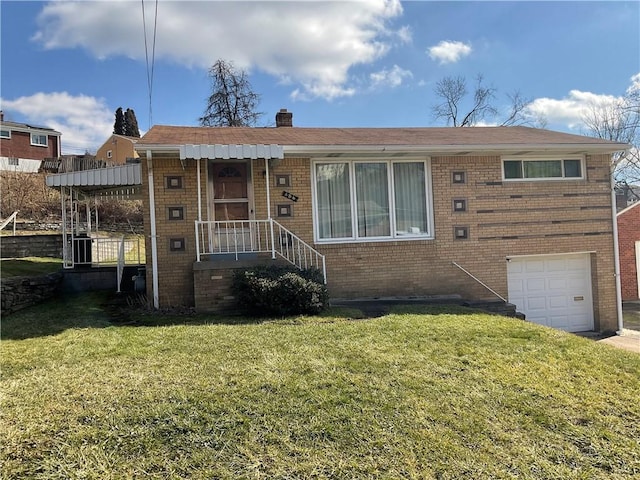 view of front of home with a garage and a front lawn