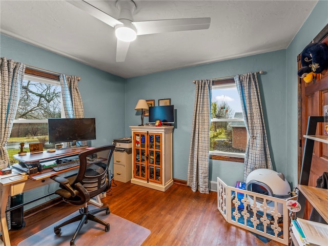 office with hardwood / wood-style flooring, a textured ceiling, and ceiling fan