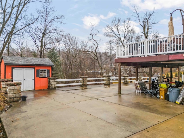 view of patio with a wooden deck and a shed