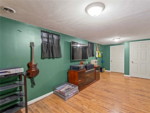 office space featuring light hardwood / wood-style floors and a textured ceiling