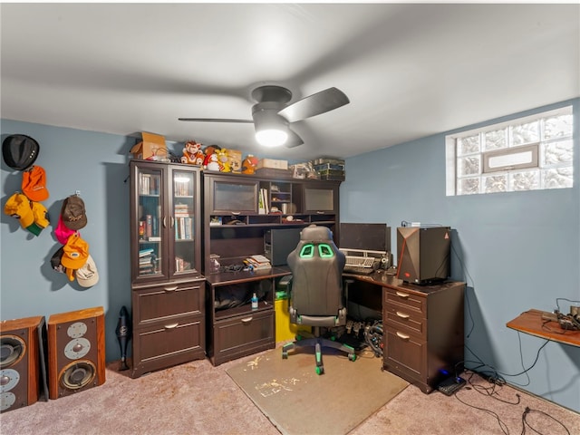 carpeted office space with ceiling fan