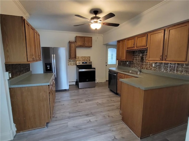 kitchen with stainless steel appliances, crown molding, sink, and tasteful backsplash