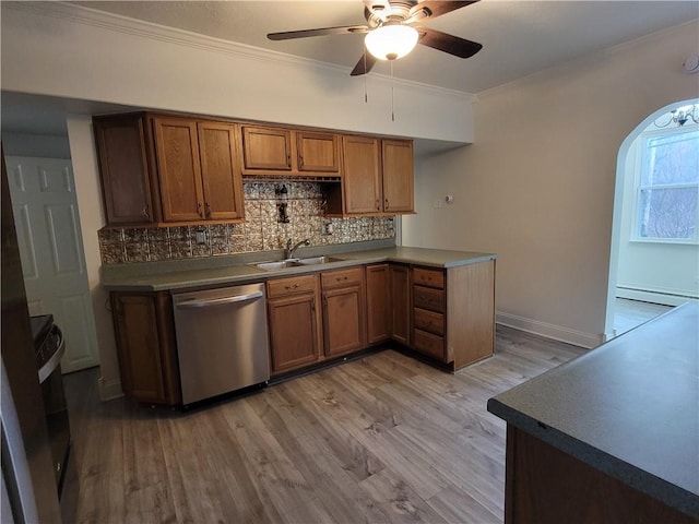 kitchen featuring sink, backsplash, stainless steel dishwasher, crown molding, and light wood-type flooring