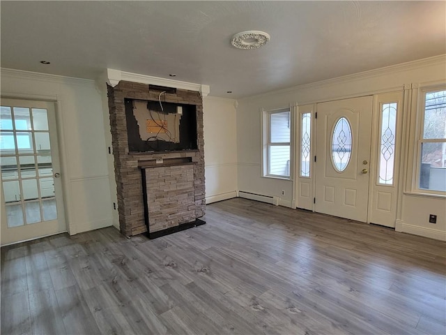 foyer with hardwood / wood-style floors, plenty of natural light, and ornamental molding