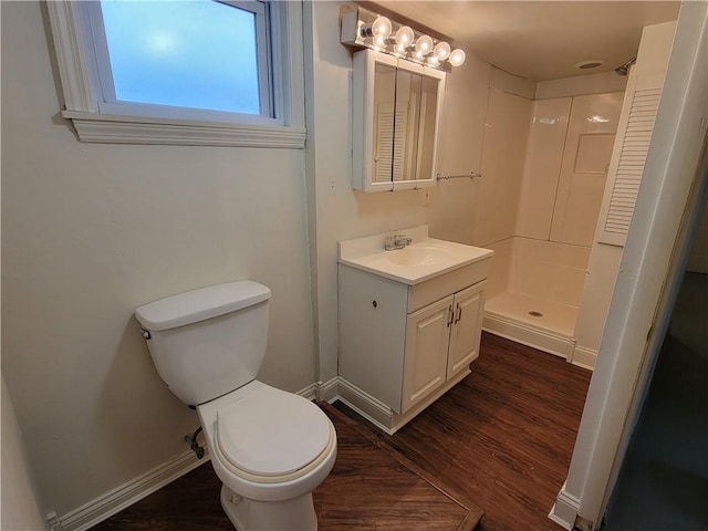 bathroom with walk in shower, wood-type flooring, toilet, and vanity