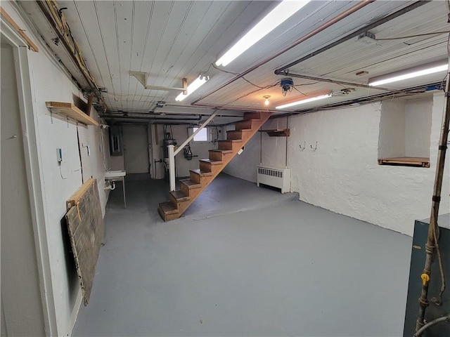 basement featuring sink and radiator heating unit