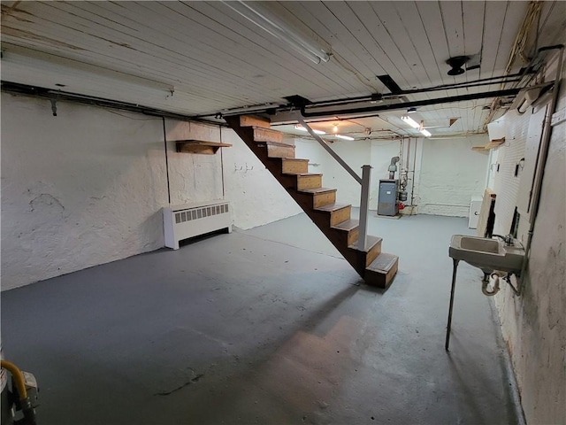 basement with sink and radiator heating unit