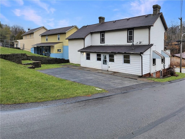 back of house featuring a lawn