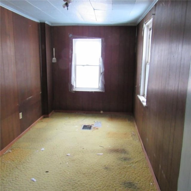 unfurnished room featuring wood walls