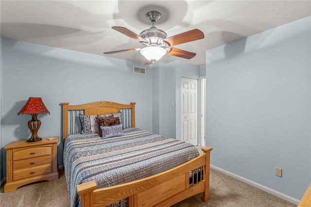 bedroom featuring ceiling fan and carpet