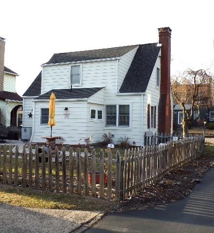 view of front of property featuring a fenced front yard and a chimney