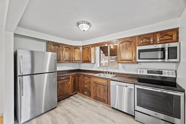 kitchen featuring sink, light hardwood / wood-style flooring, and stainless steel appliances