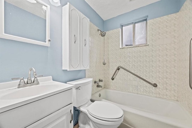 full bathroom featuring vanity, tiled shower / bath combo, and toilet