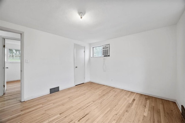 unfurnished room featuring a healthy amount of sunlight and light hardwood / wood-style flooring