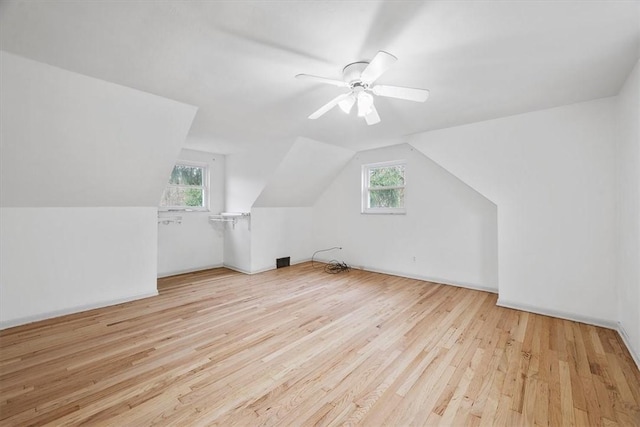 additional living space with plenty of natural light, light hardwood / wood-style floors, ceiling fan, and vaulted ceiling