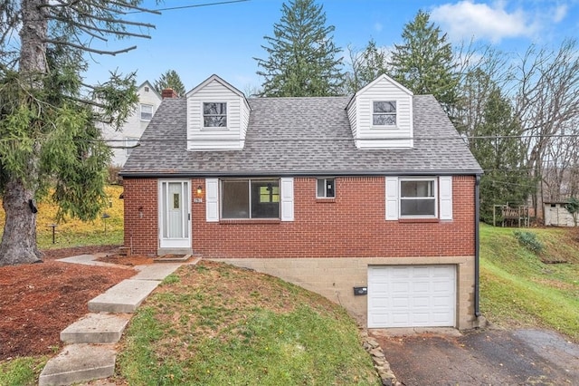 cape cod-style house with a garage and a front lawn