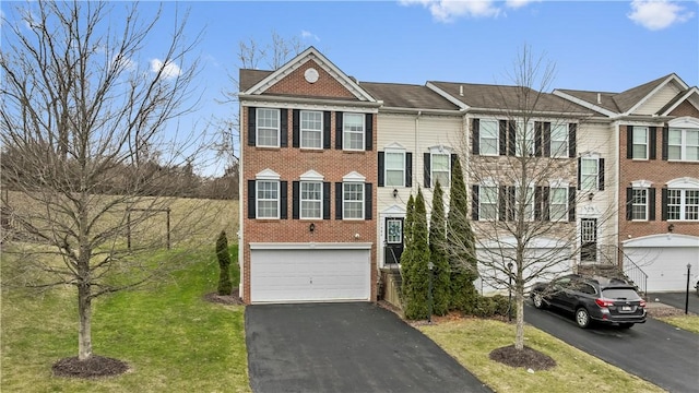 view of front of home featuring a garage and a front yard