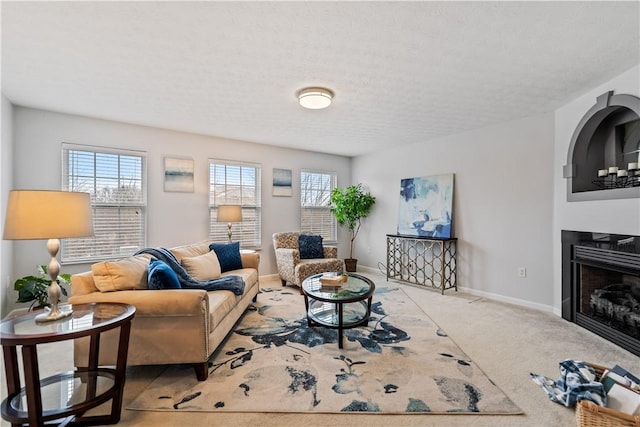 carpeted living room featuring a textured ceiling