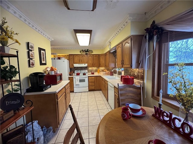 kitchen featuring light tile patterned flooring, sink, backsplash, ornamental molding, and white appliances