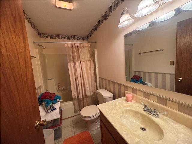 full bathroom featuring tile patterned floors, vanity, toilet, and shower / bath combo