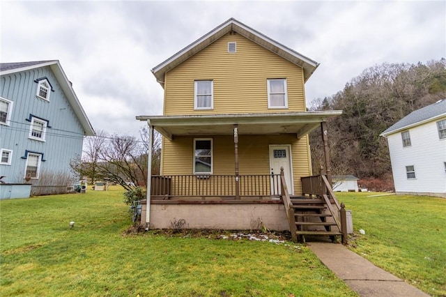 view of front of house with a front yard and covered porch