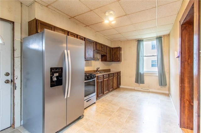 kitchen with stainless steel appliances and a paneled ceiling