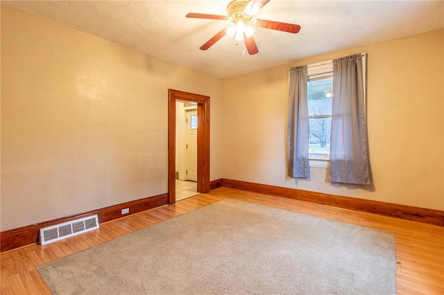 spare room featuring ceiling fan and light wood-type flooring