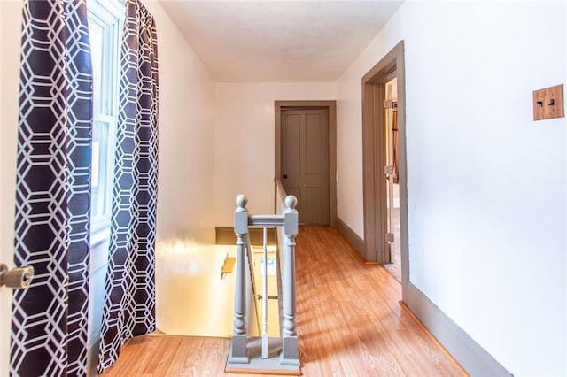 hallway with hardwood / wood-style floors