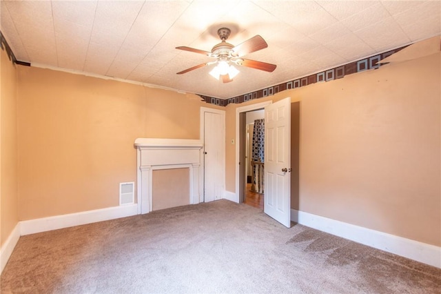 unfurnished bedroom featuring ceiling fan and carpet floors