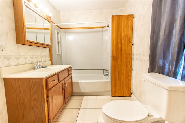 full bathroom with bathing tub / shower combination, tile walls, vanity, tile patterned floors, and toilet