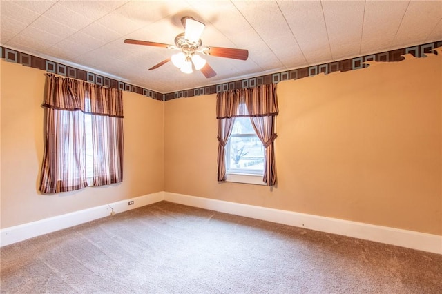 empty room featuring carpet floors and ceiling fan