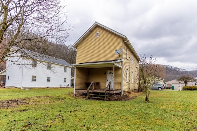 back of house featuring a yard