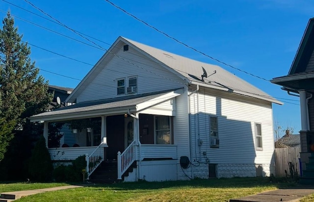 view of front of house with a front yard and covered porch