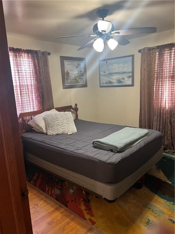 bedroom with light hardwood / wood-style flooring and ceiling fan