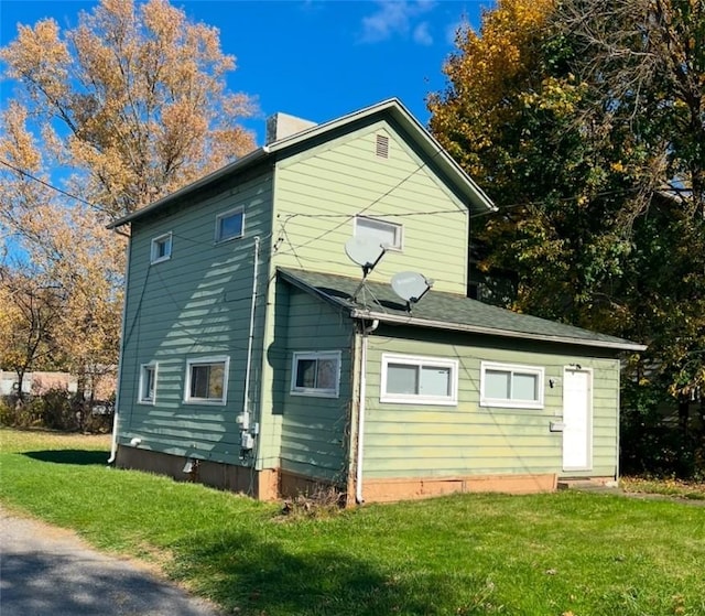 view of side of home featuring a yard