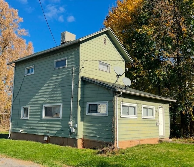 view of property exterior featuring a lawn