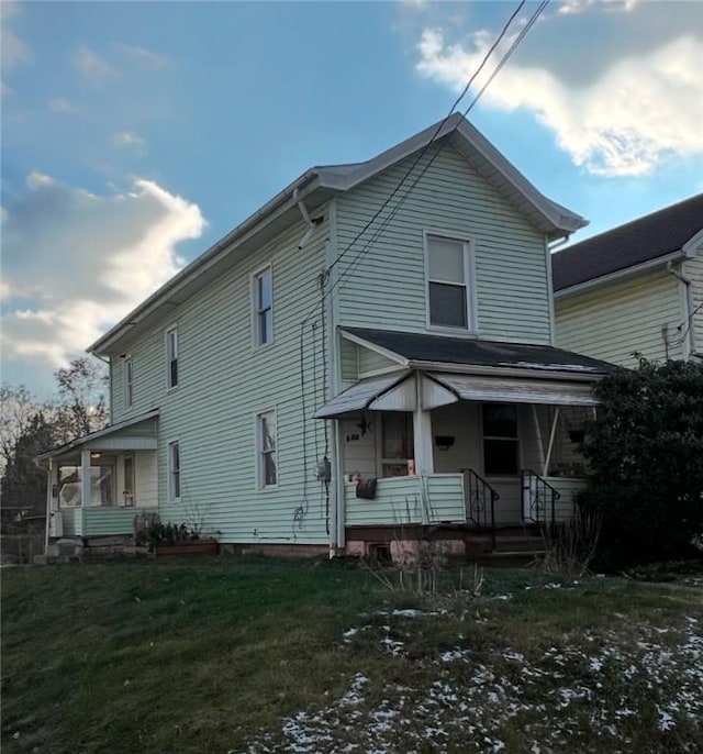 view of front property with a porch and a front lawn