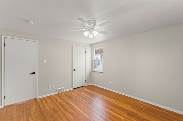 unfurnished room featuring hardwood / wood-style flooring and ceiling fan